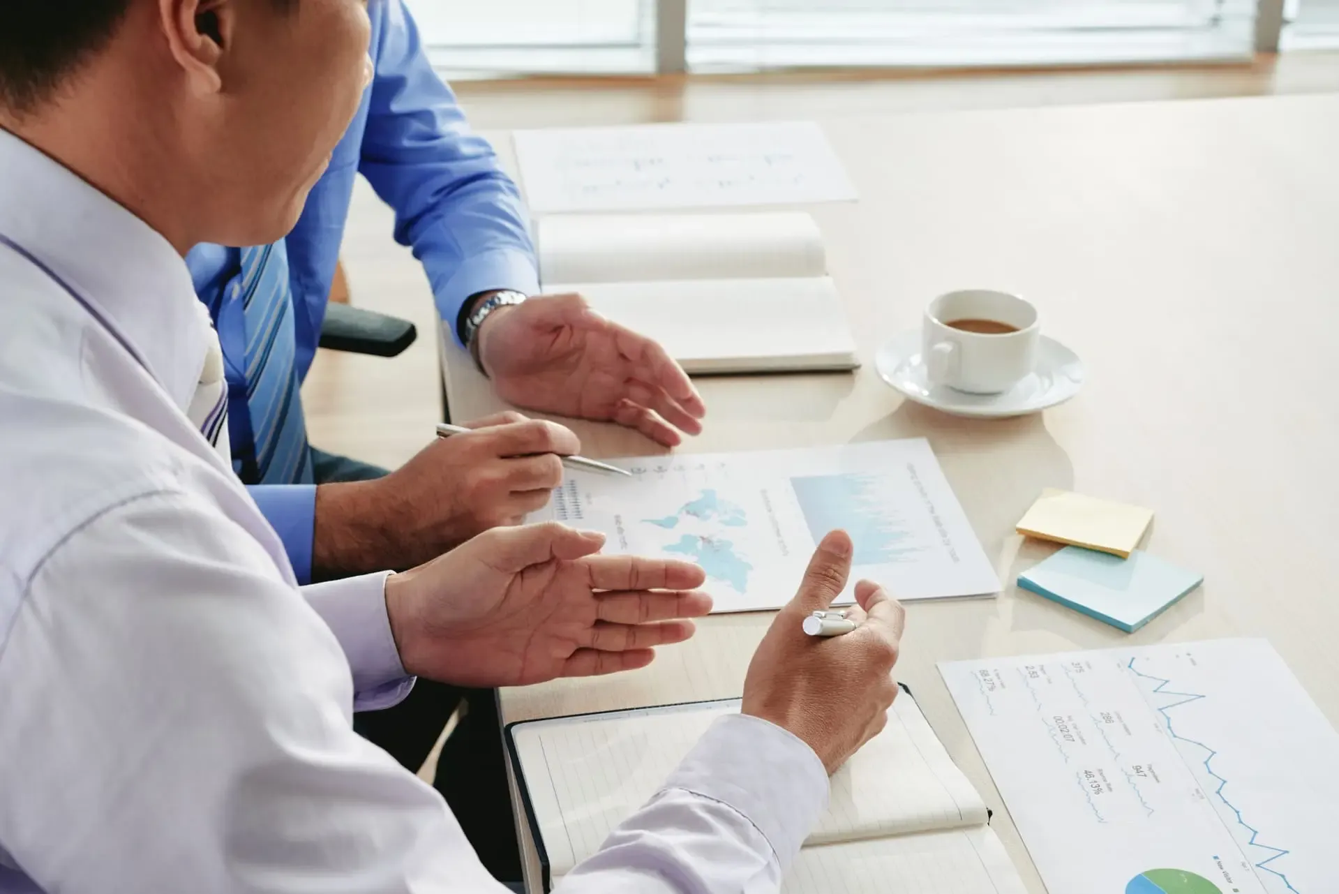 Cropped Businessmen Discussing Analytical Visuals Working Business Strategy