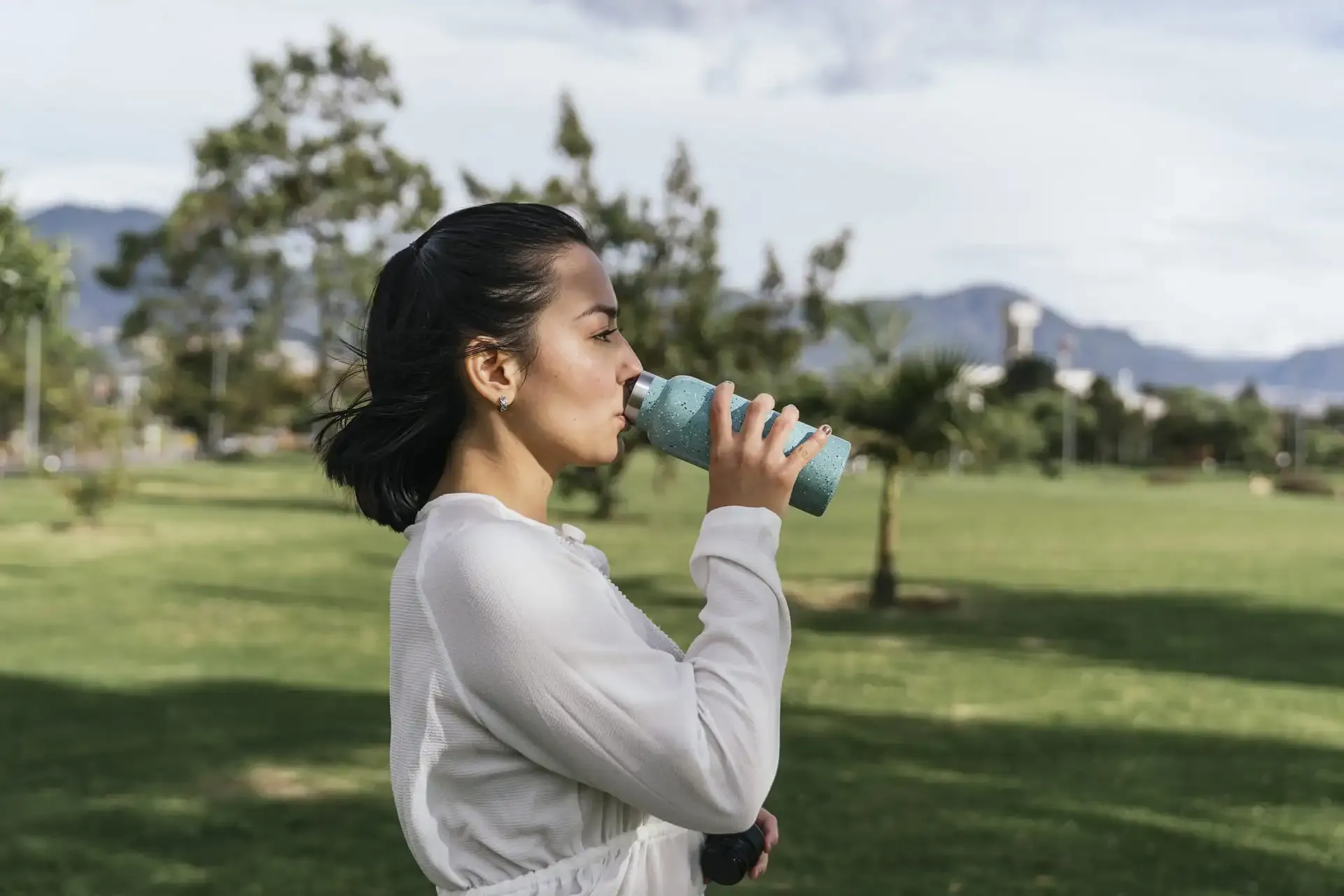 Hispanic Female Resting By Drinking Water After Yoga Practice