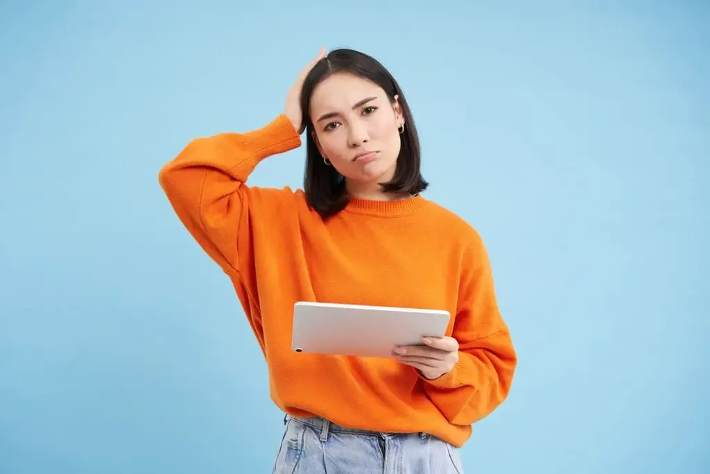 Woman With Digital Tablet Looks Confused Cant Understand Smth Her Gadget Stands Puzzled Against B